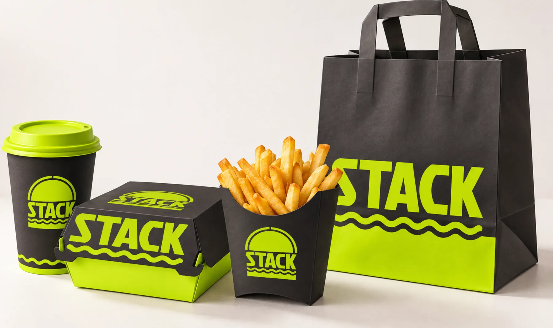 STACK packaging: a black and lime cup, burger box, fry carton and takeaway bag
